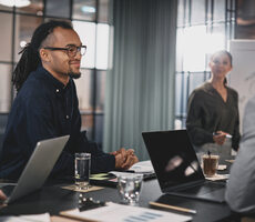 businessman in meeting discussing outcome based solutions